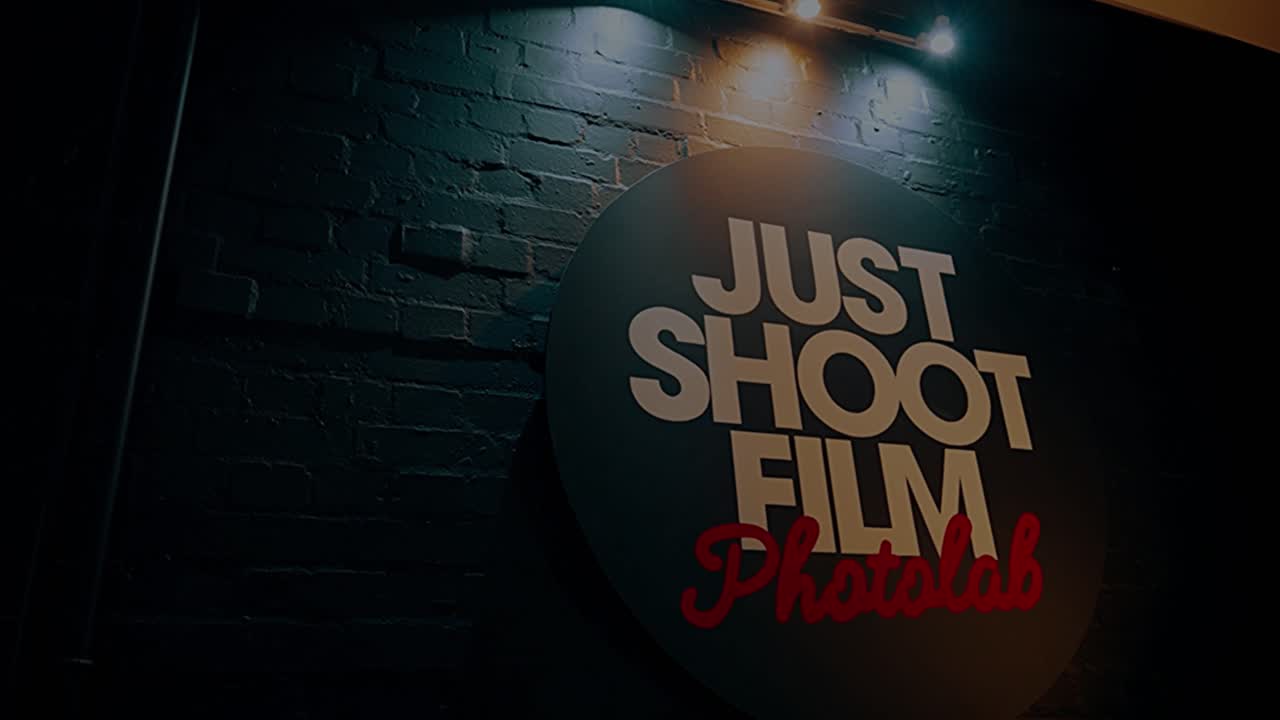 The Just Shoot Film Photolab sign on the brick wall of the lab in Norwich