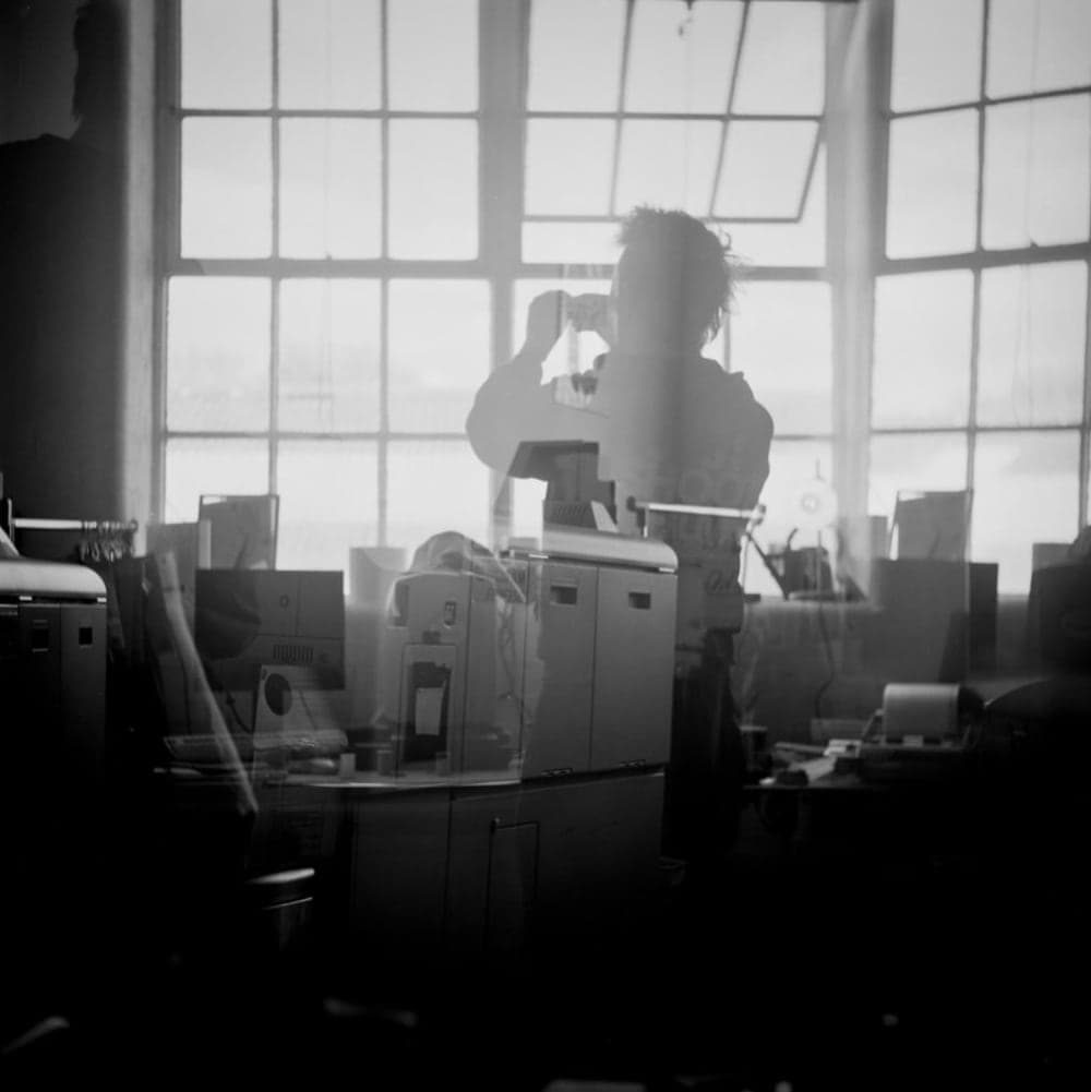 David photographed in the lab, in front of the big windows, on black and white film