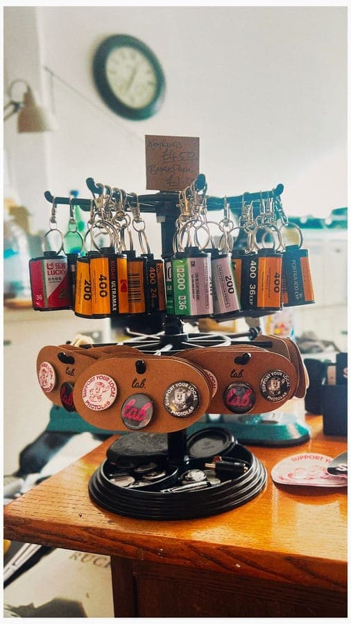 Film canister keyrings on a stand on the lab counter