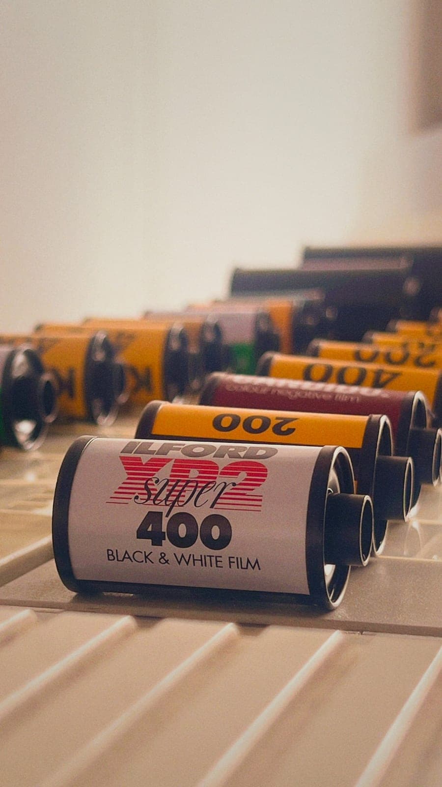 A roll of Ilford XP2 Super 400 in front of a row of 35mm films